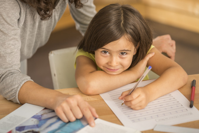 Mother and daughter doing homework together.